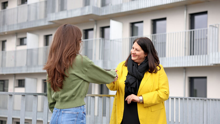 Kathrin Gaál steht einer langhaarigen jungen Frau gegenüber. Die Vizebürgermeisterin schüttelt der Frau die Hand.